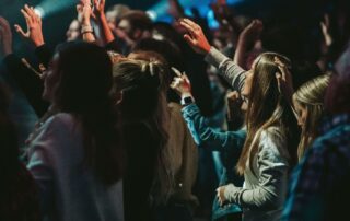 A group of people lifting their hands and worshiping God.