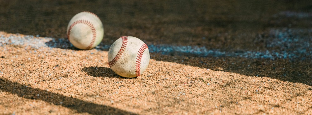 Two baseballs on a field