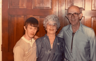 A group photo of Don and his parents, Wilbur and Opal, smiling at the camera.