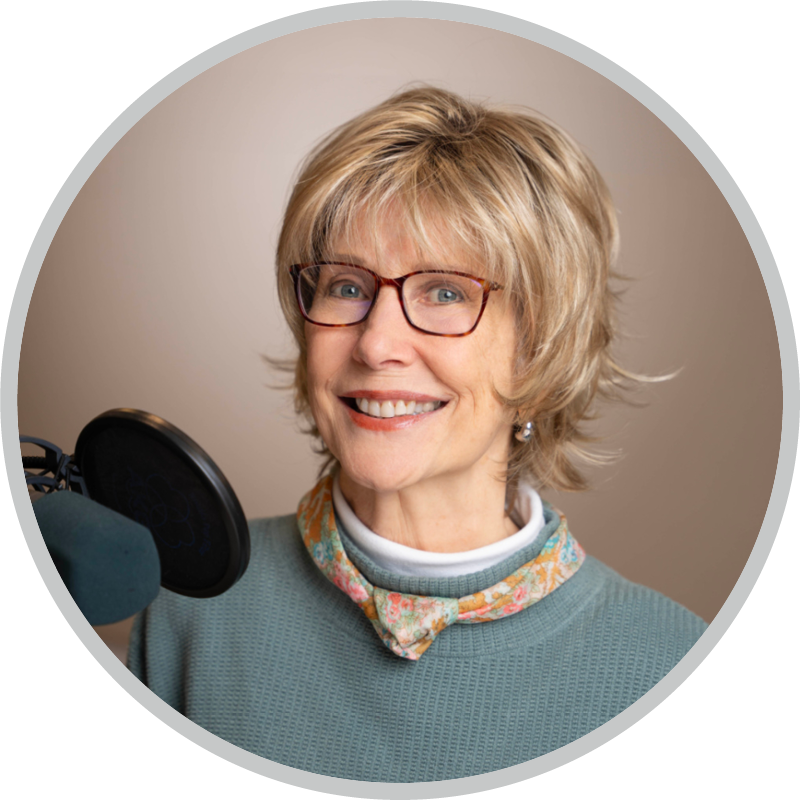 Joni Eareckson Tada smiling for the camera with a microphone in front of her. 