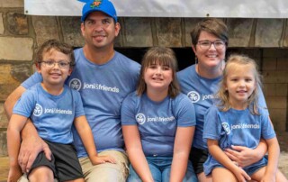 Family photo of five individuals—Charlie, Candice, Huntleigh, Henley, and Haelyn—smiling at the camera during a Joni and Friends family retreat.