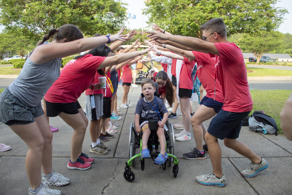 Carson in his wheelchair arriving at the Family Retreat receiving a warm welcome by volunteers and staff of Joni and Friends.