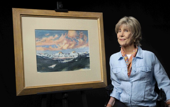 Joni next to her Mountain Majesty artwork