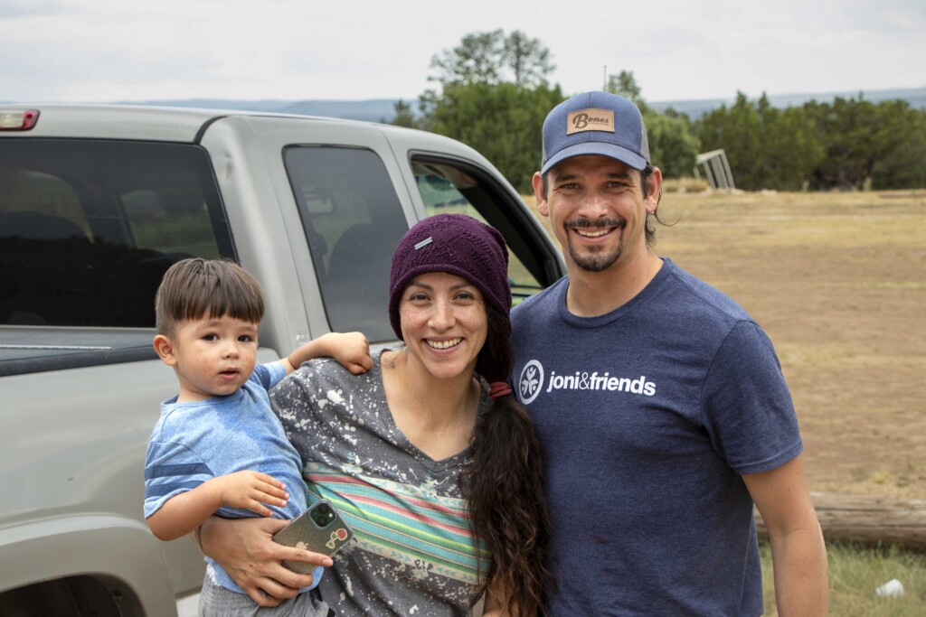 Deborah and David are smiling at the camera, while Deborah holding their son, Benny.