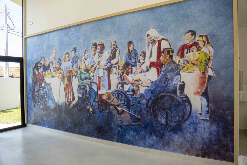 Mural of the Luke 14 Banquet depicting people with disabilities gathering at a banquet with Jesus.