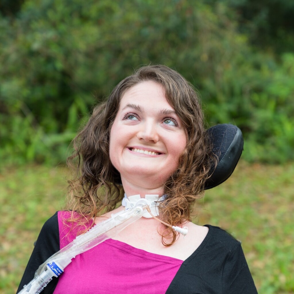 Paige Snedeker smiling and looking at the skies.