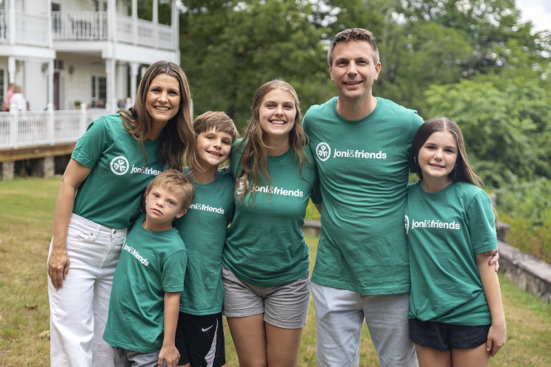 A family in green Joni and Friends t-shirts at a Family Retreat