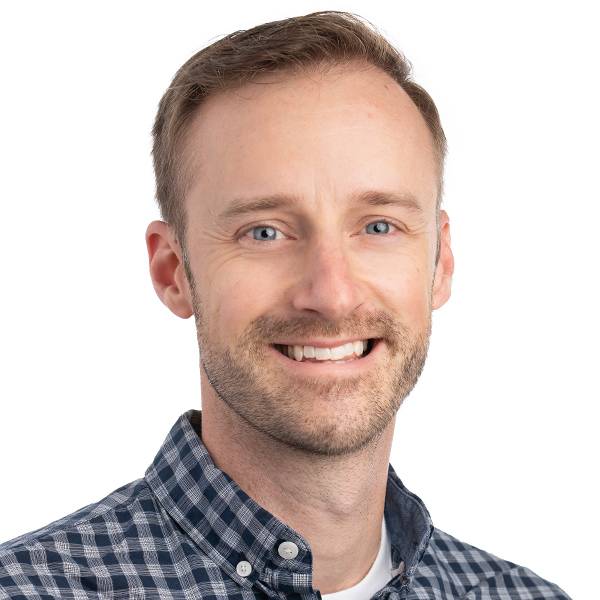 A headshot of Aaron Gray smiling for the camera.