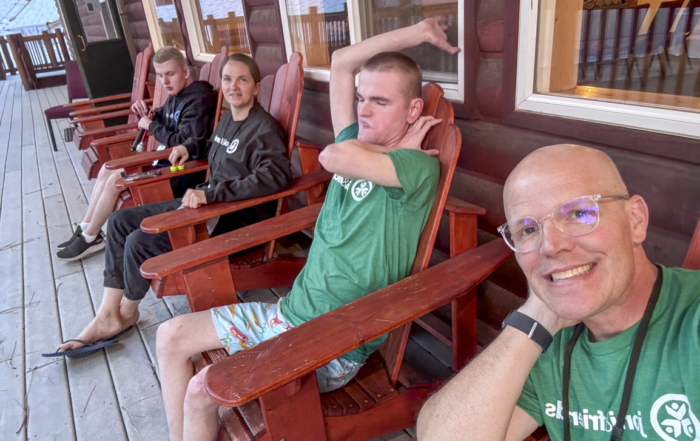 Jared, Dino, Laura, and Tyson Graham sitting together and enjoying a relaxing moment. They are dressed in outfits featuring the Joni & Friends logo.