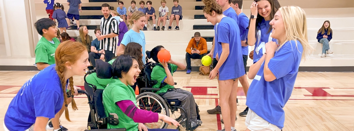 People of all abilities smiling, laughing, and playing dodgeball