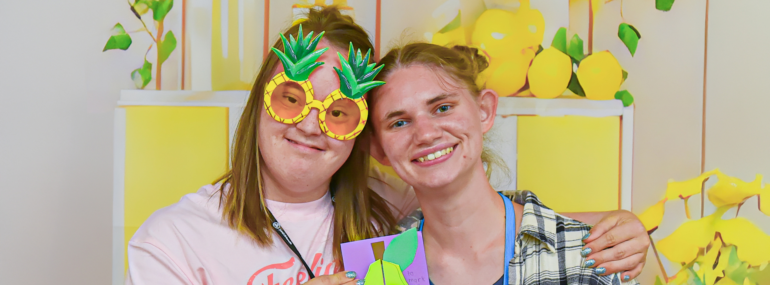 Two smiling girls pose for the camera as they have a great time at Family Retreat.