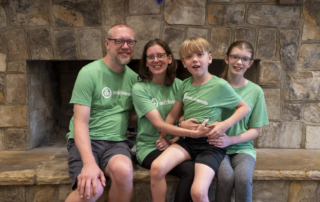 The Apperson Family – Ben, Dawn, Elijah, and Alexa Anne – sitting together and smiling for the camera.