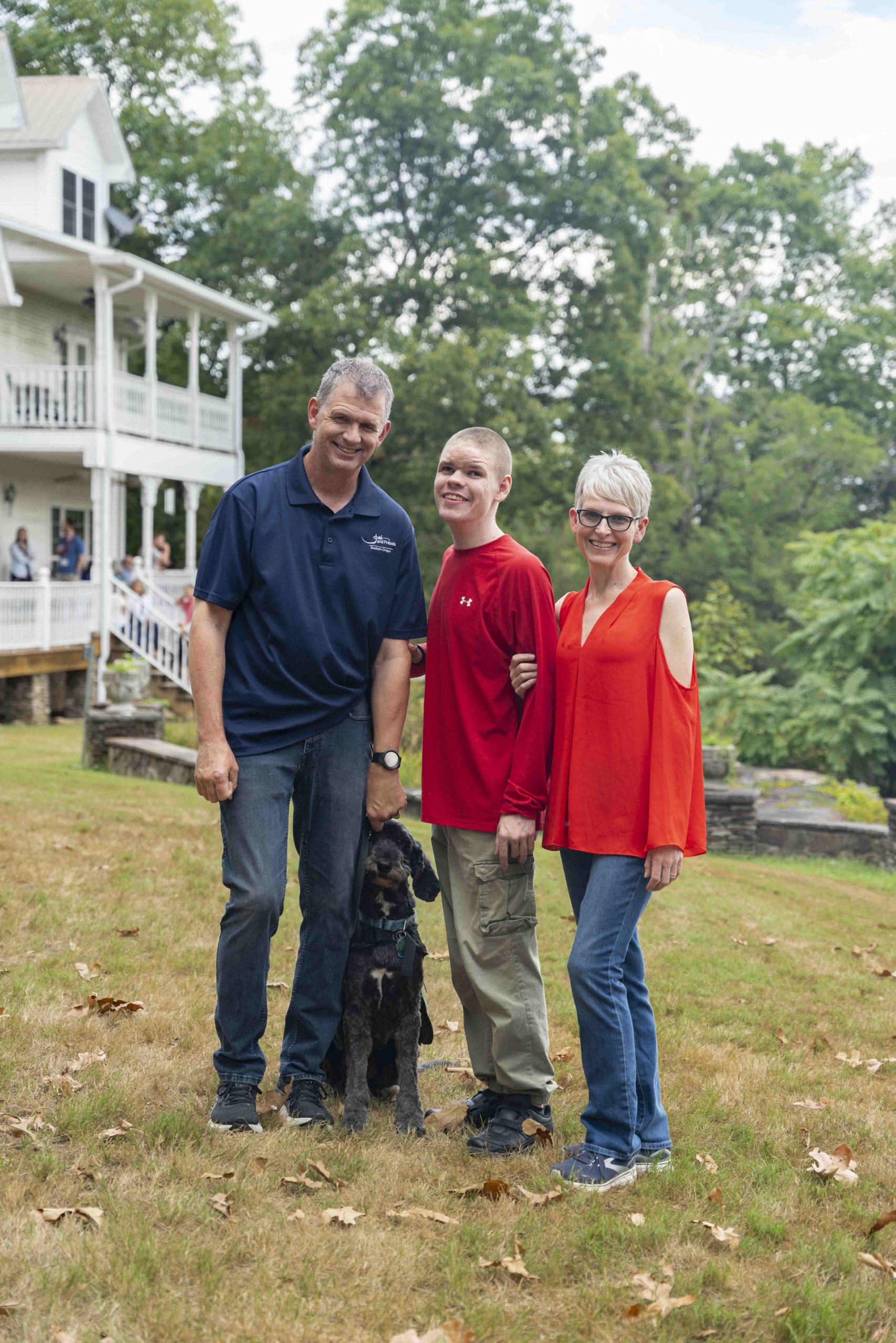 Will, Noah, and JJ smiling brightly and posing for the camera outdoors, enjoying their time at the Family Retreat.