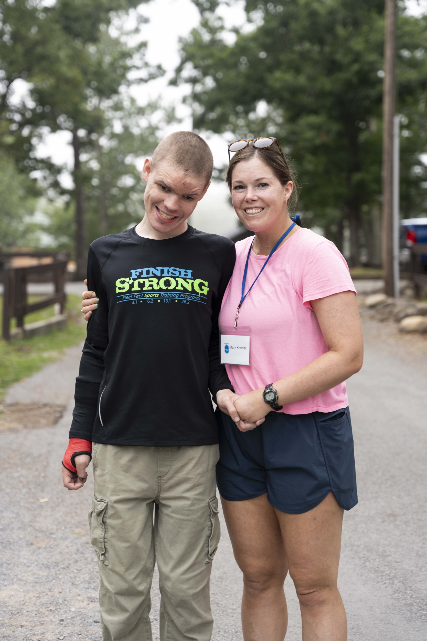 Noah and Mary Kendall standing side by side, smiling happily as they pose for the camera during the Family Retreat.