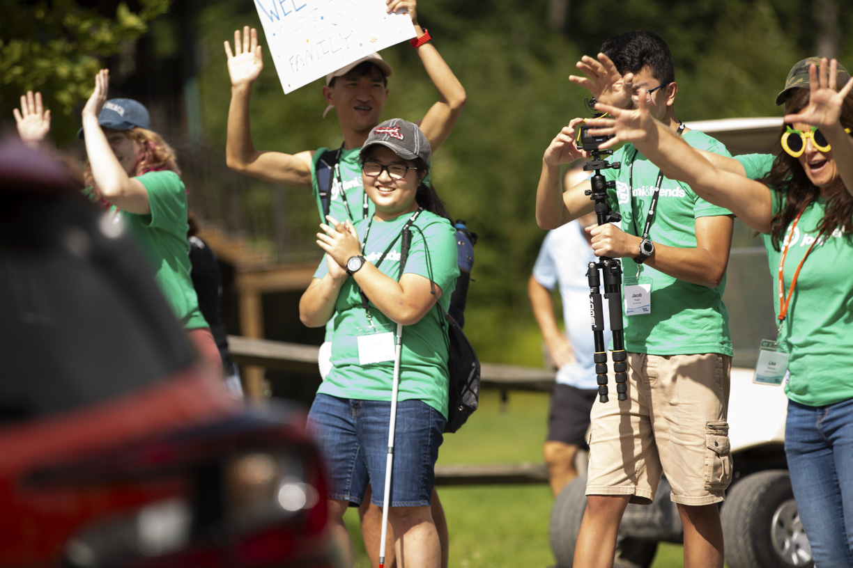 Zoey, Caleb, and Jacob welcoming families as they serve at Family Retreat.