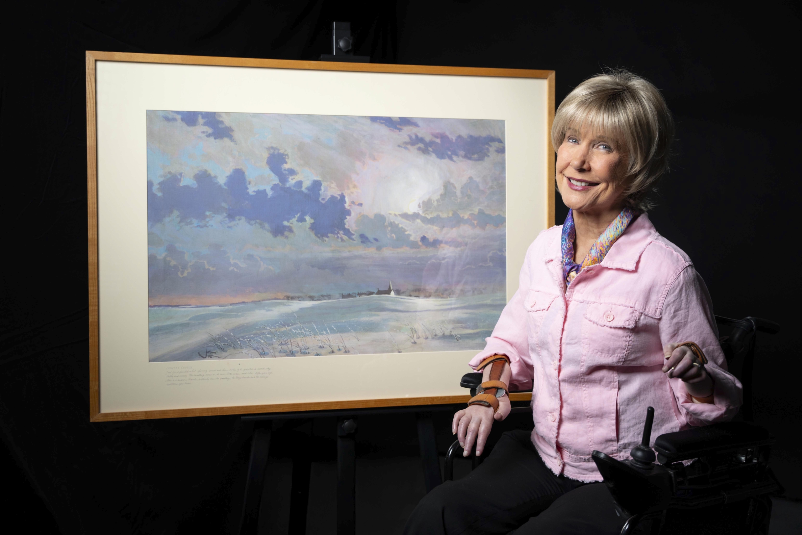 Joni next to her artwork A Country Church.