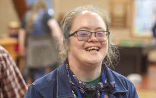 Emily Satterberg smiling and having fun while posing for the camera during Family Retreat.