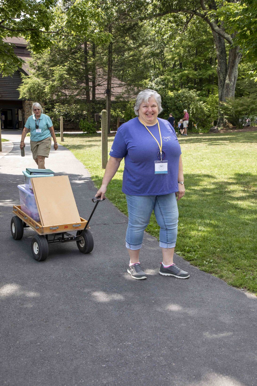 Deb Butcher pulling a trolley with various items.