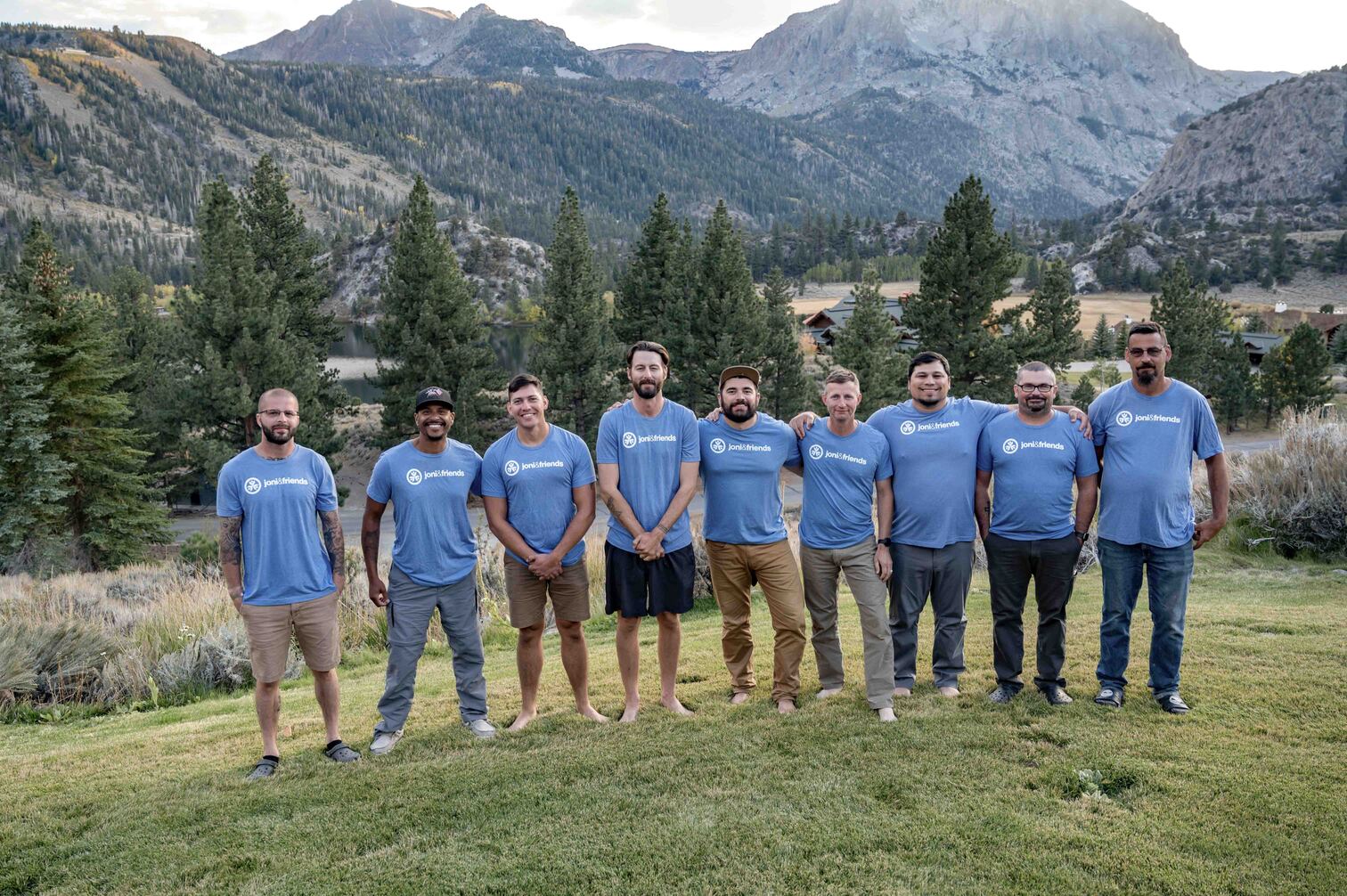 JB with other veterans during Warrior Getaway, with beautiful mountains behind them.