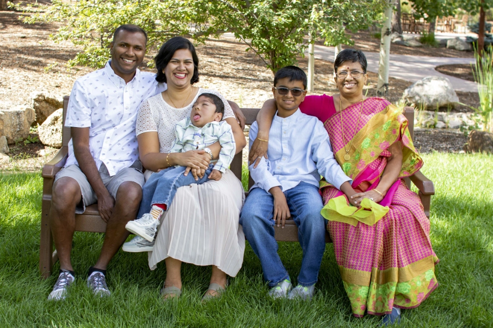 A family sitting on a bench poses for a photo at Family Retreat