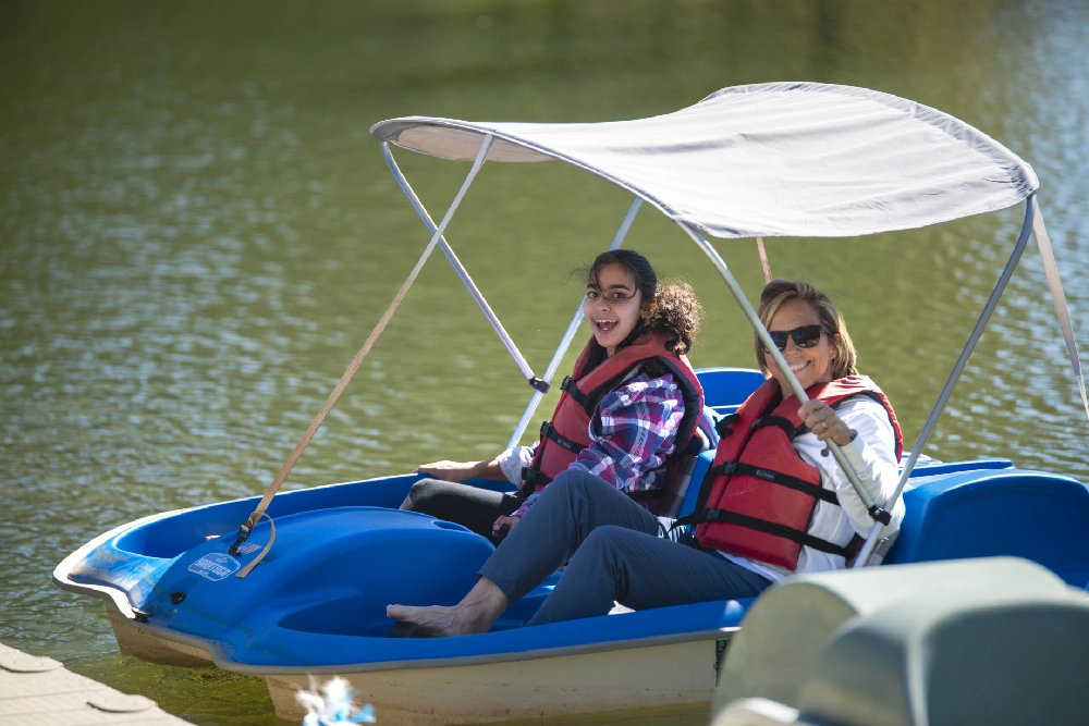 Campers in a paddle boat at Family Retreat