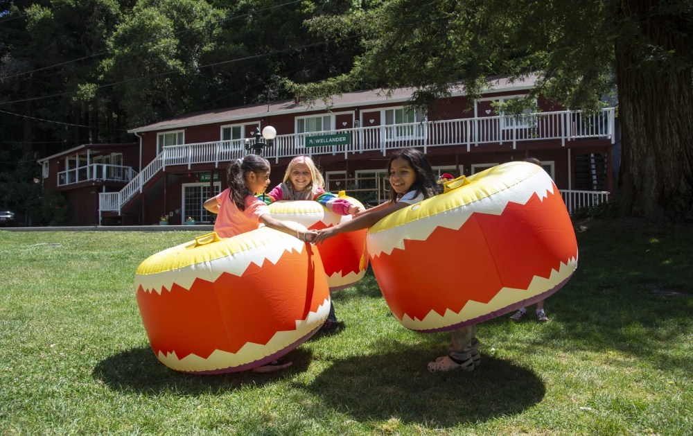Children play with inflatable bumpers at Family Retreat