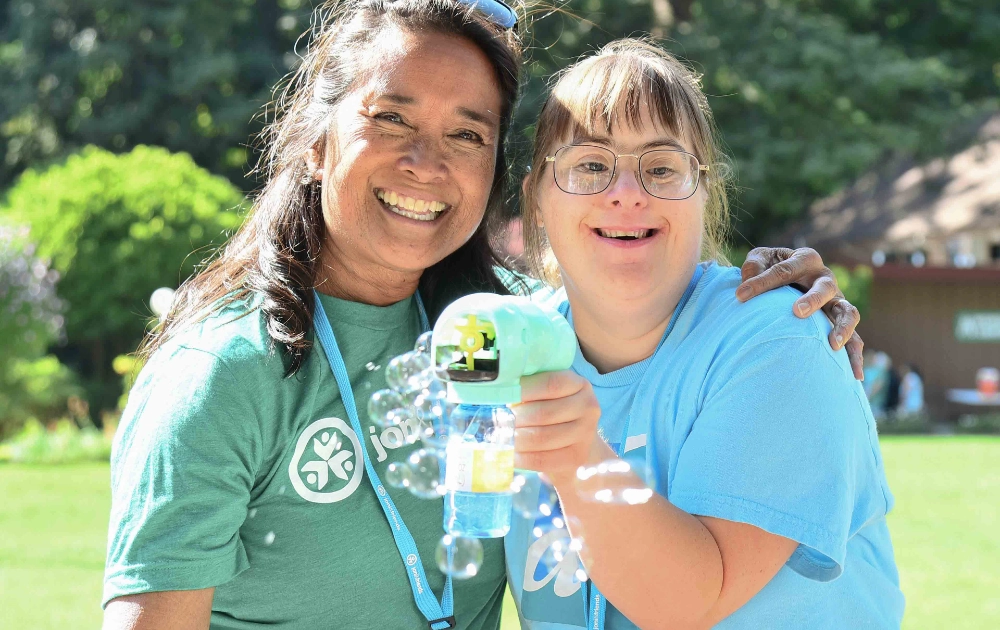 Campers with a bubble gun pose for a photo