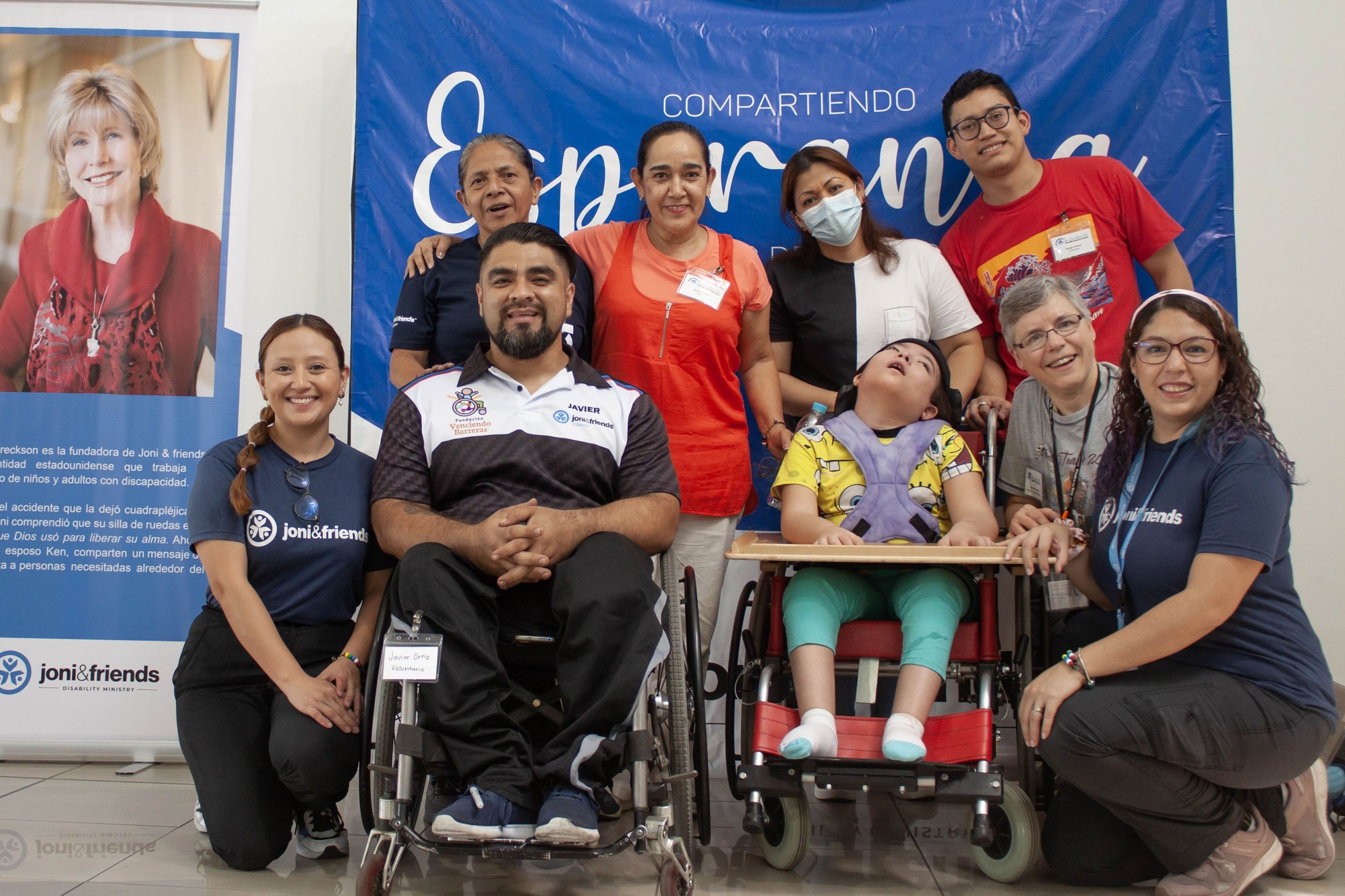 Imelda Cuevas with Joni and Friends staff and volunteers, alongside a young boy participant in a wheelchair.