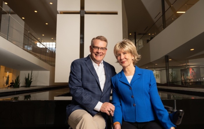 Shawn and Joni next to each other. Behind them is Joni and Friends' iconic floating chapel.