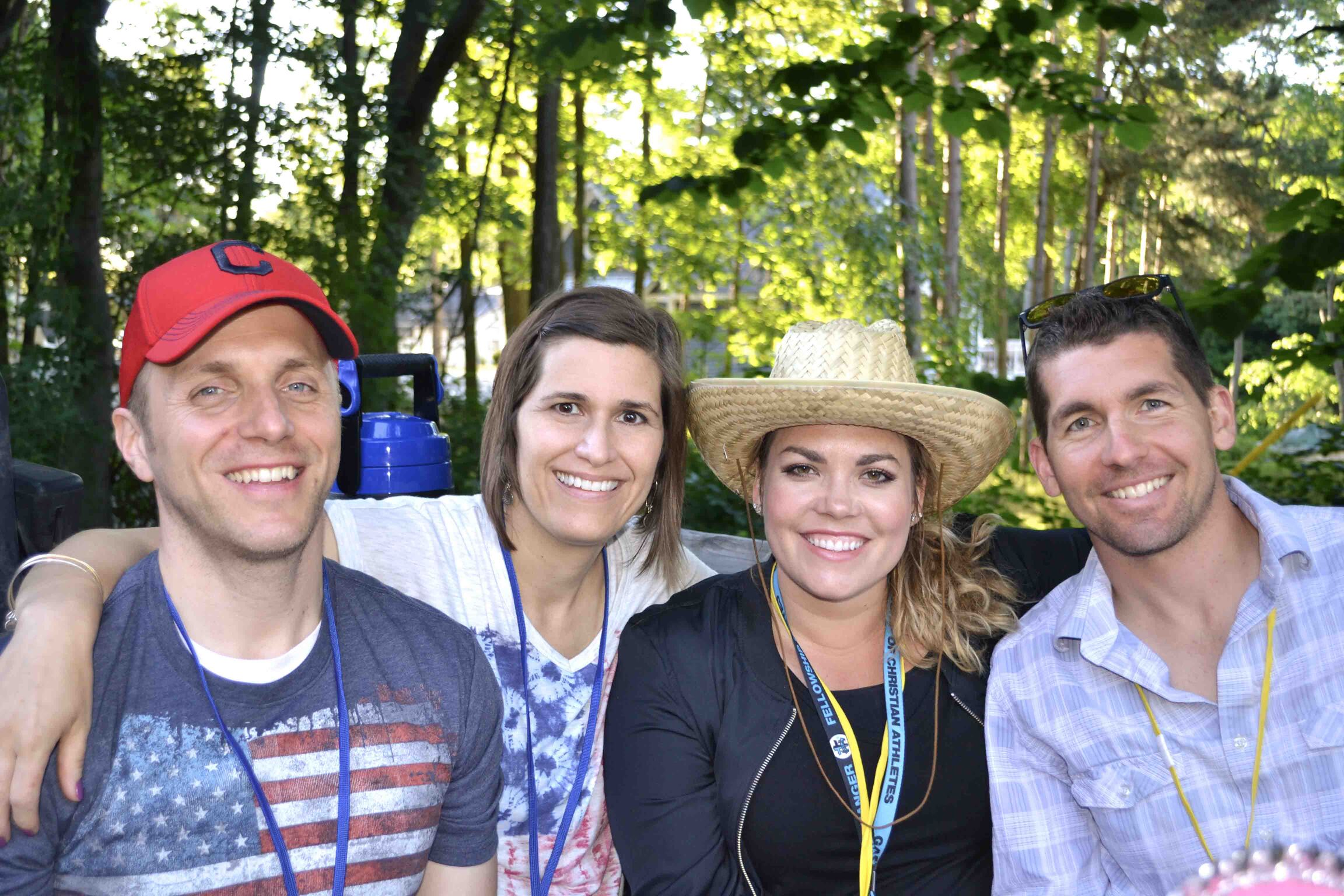 Paul and Kathy, along with a woman and a man, smiling and posing for the camera.