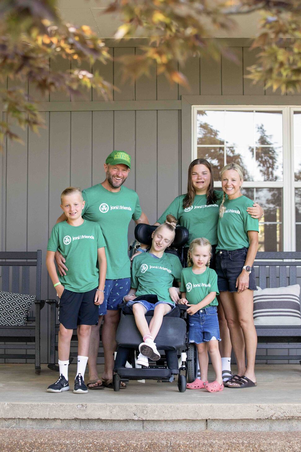 Ty and Rachel with their four children, all posing for the camera and wearing Joni and Friends T-shirts.