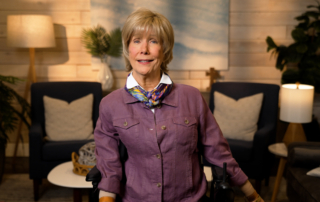 Joni Eareckson Tada smiling for the camera in a cozy living room setup.