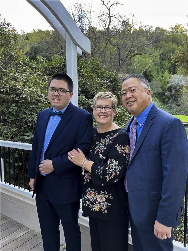 Kendall, Stephanie, and Chris Sue wearing formal outfits and smiling for the camera.