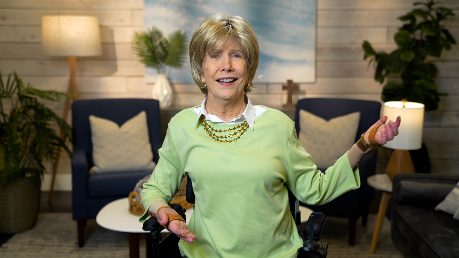 Joni Eareckson Tada smiling for the camera in a cozy living room setup.