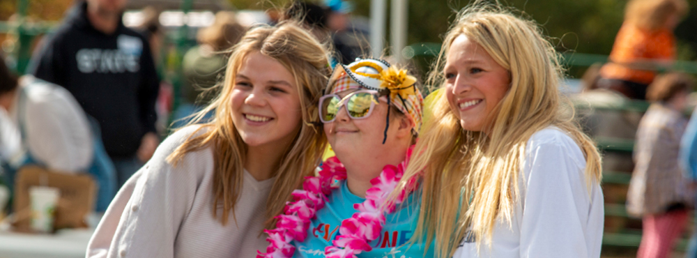 Smiling attendees are having fun at Barnyard Bash!