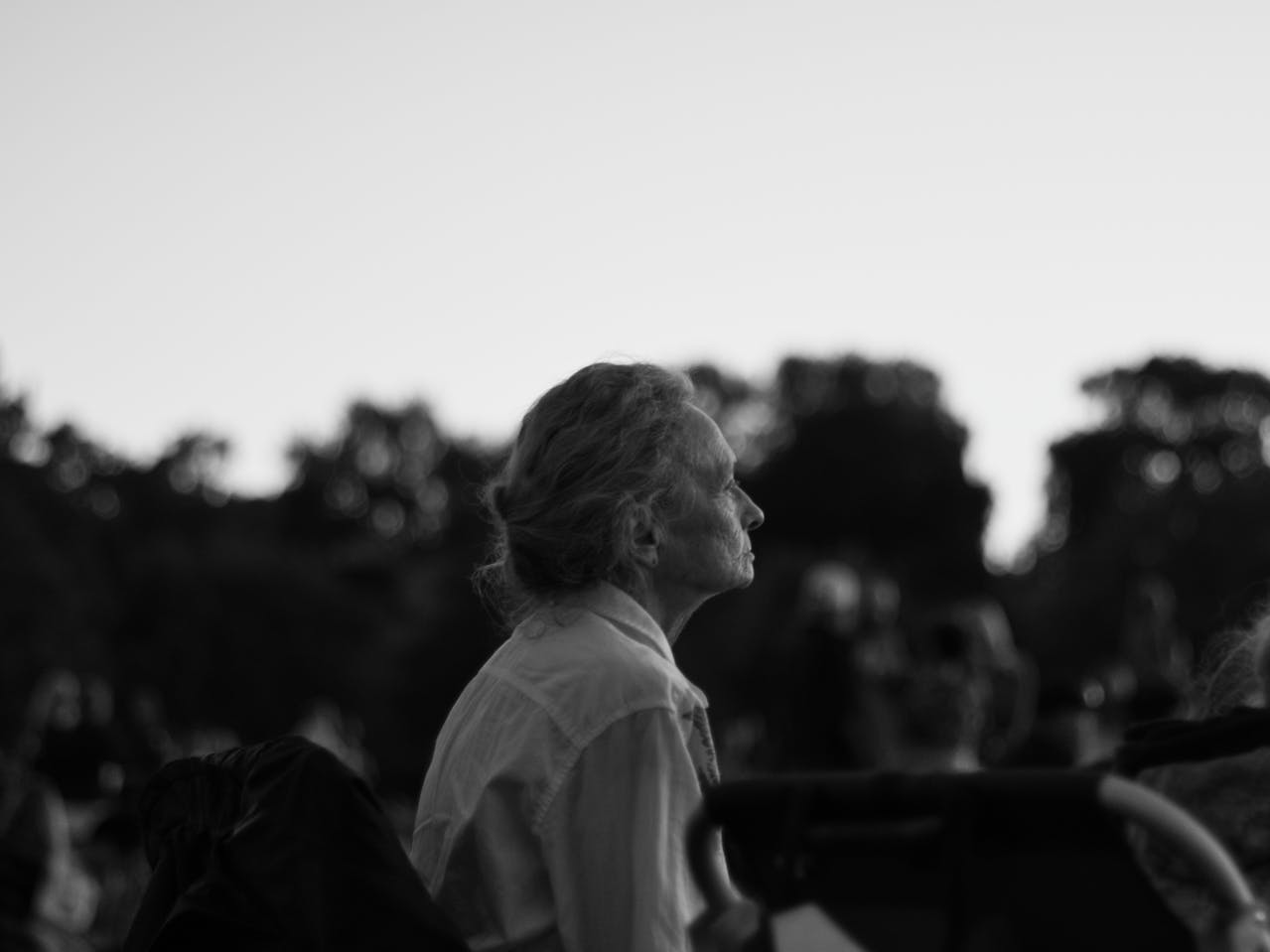 An elderly woman gazing into the distance.