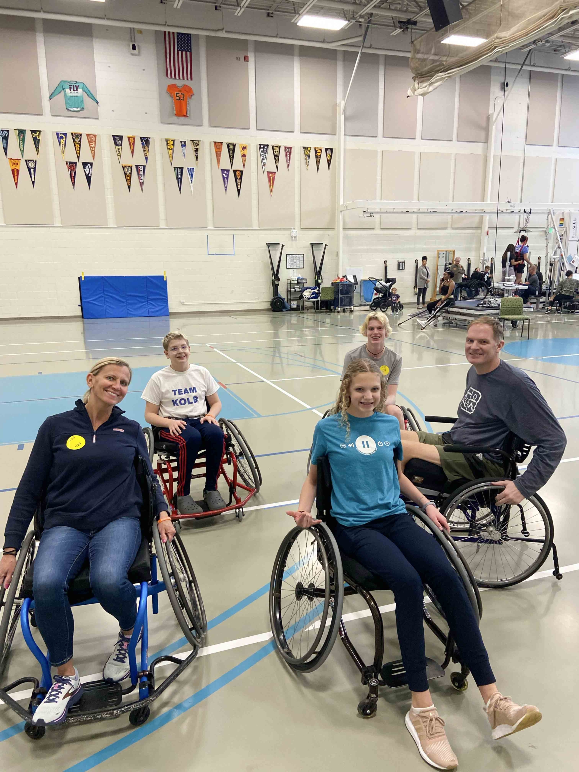 Jason in his wheelchair with other people in their wheelchairs.