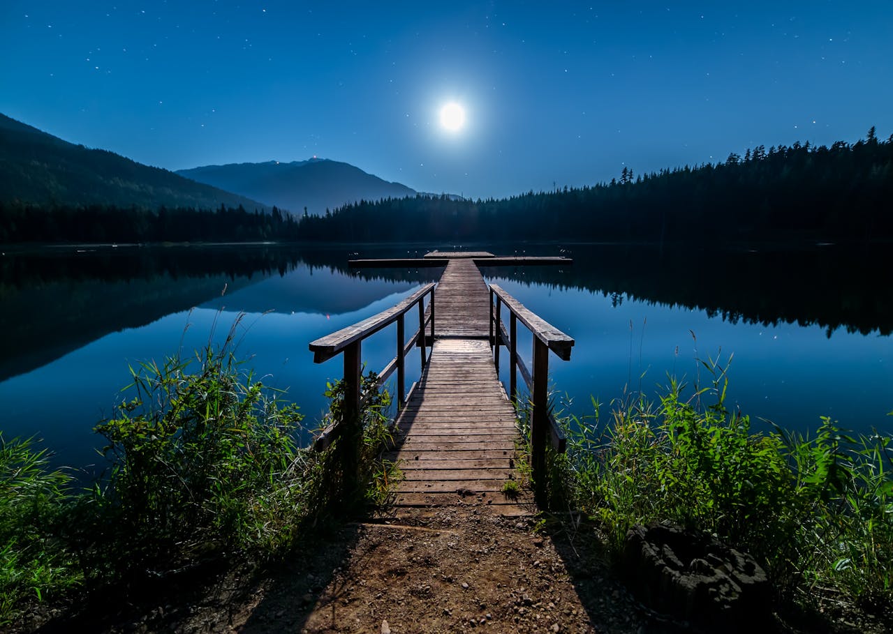 Peaceful night with a wooden dock on the river with the moonlight