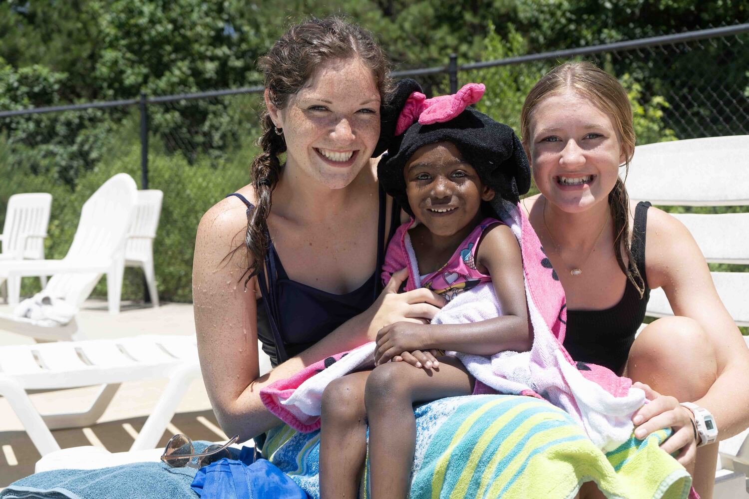 Taliyah with two other volunteer. All are smiling and posing for the camera.