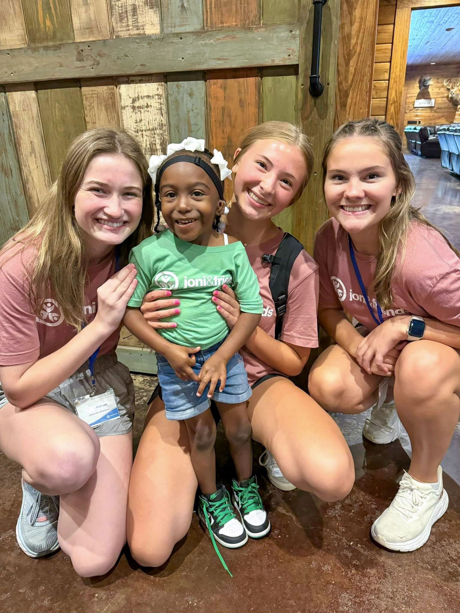 Taliyah with three other volunteers smiling and posing for the camera.