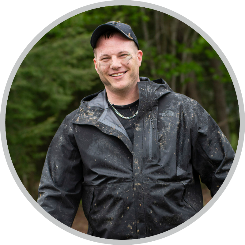 Mark Stallion smiling and enjoying his time at Warrior Getaway with mud all over his face.