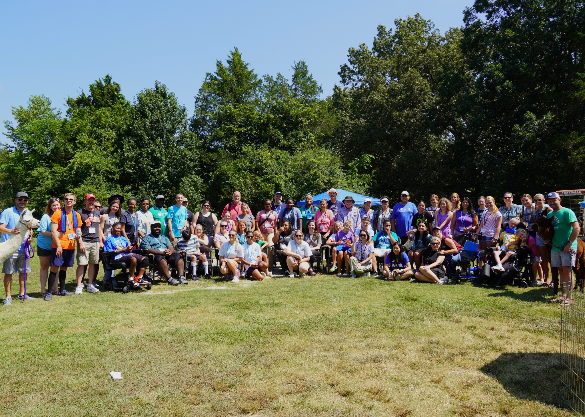 Large group photo of Maria Lee with staff and participants at the Joni and Friends Family Retreat, all smiling and gathered outdoors.