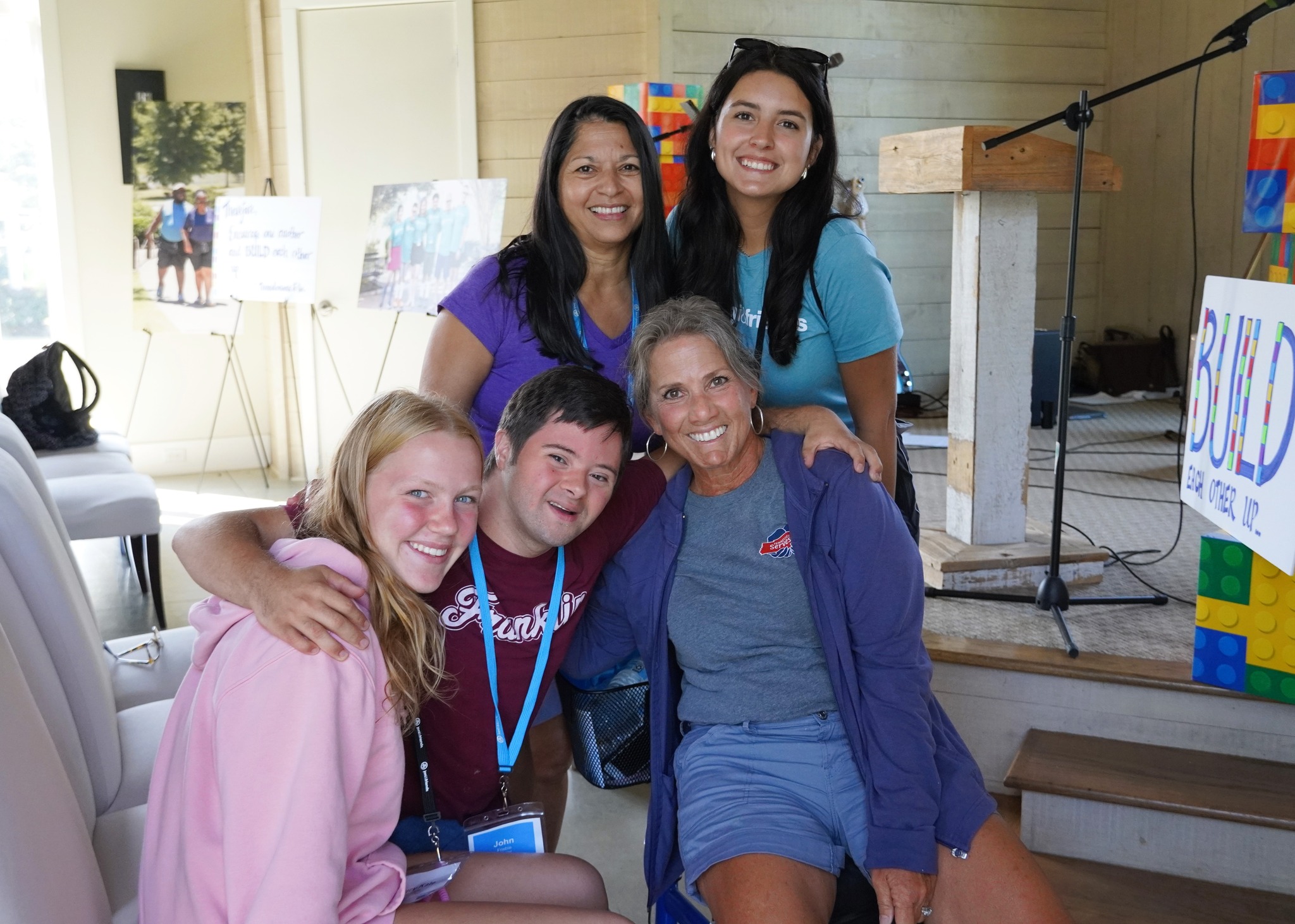 Maria Lee standing with staff and participants at a Joni and Friends event, smiling and posing for a group photo.