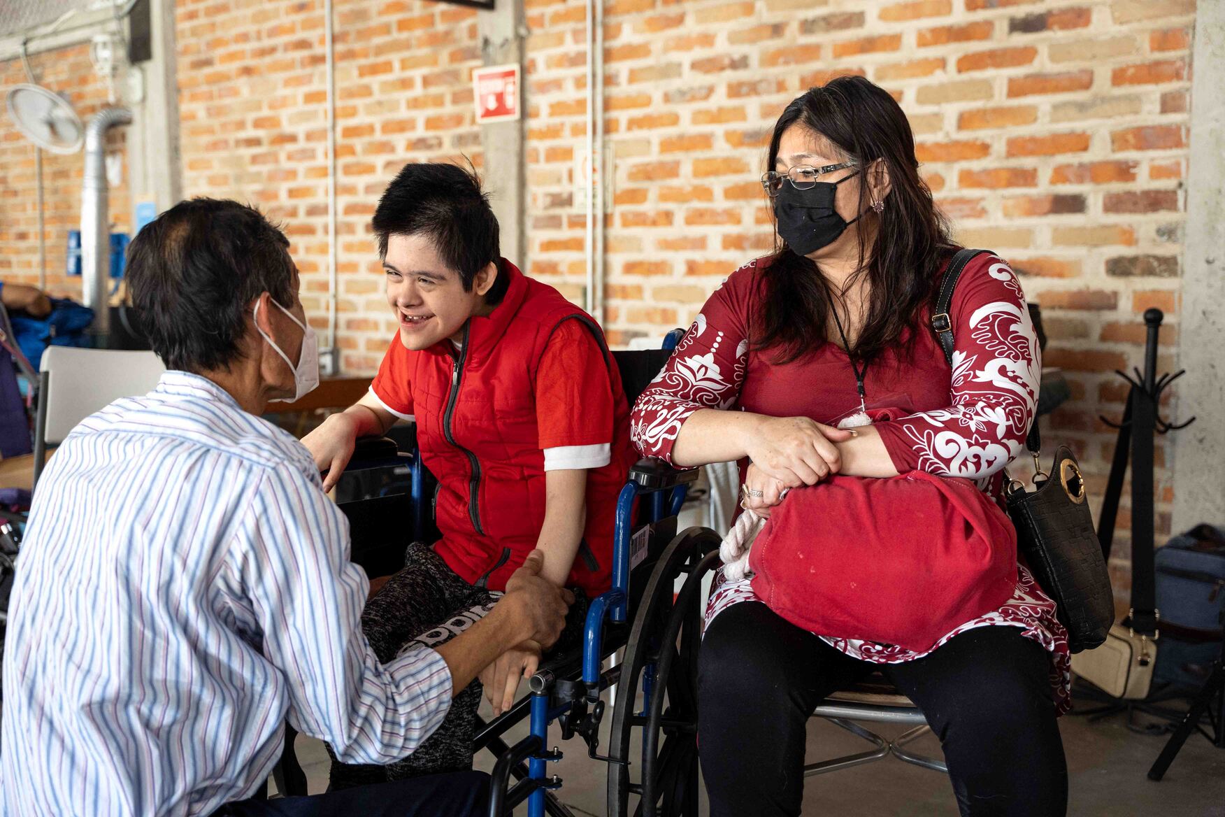 Donovan smiling happily as he looks at his dad, with his mom sitting beside him.