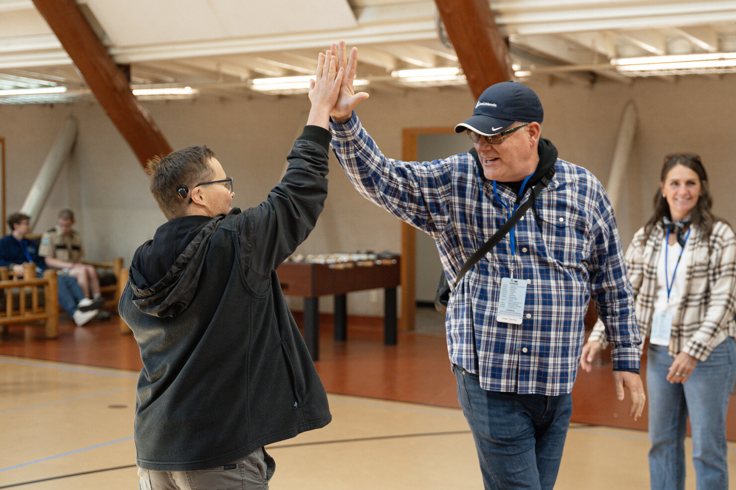Paul and Shawn high-fiving each other in the middle of a basketball court.