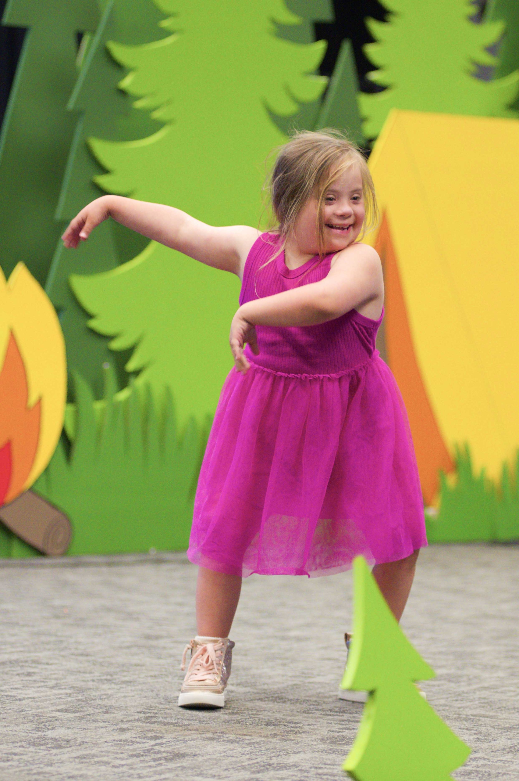 Lily dancing and smiling joyfully.