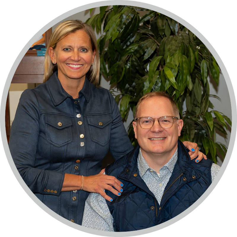 Dr Jason and Amy Kolb sitting next to each other and smiling for the camera.