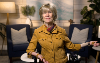 Joni Eareckson Tada smiling for the camera in a cozy living room setup.