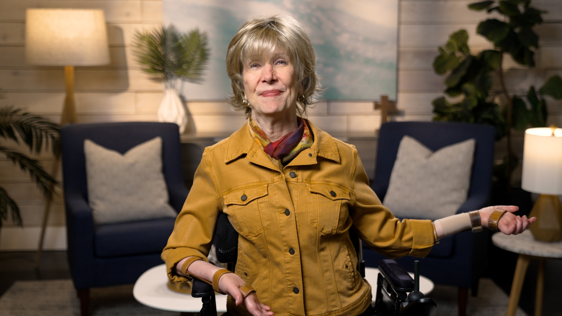 Joni Eareckson Tada smiling for the camera in a cozy living room setup.