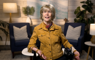 Joni Eareckson Tada smiling for the camera in a cozy living room setup.